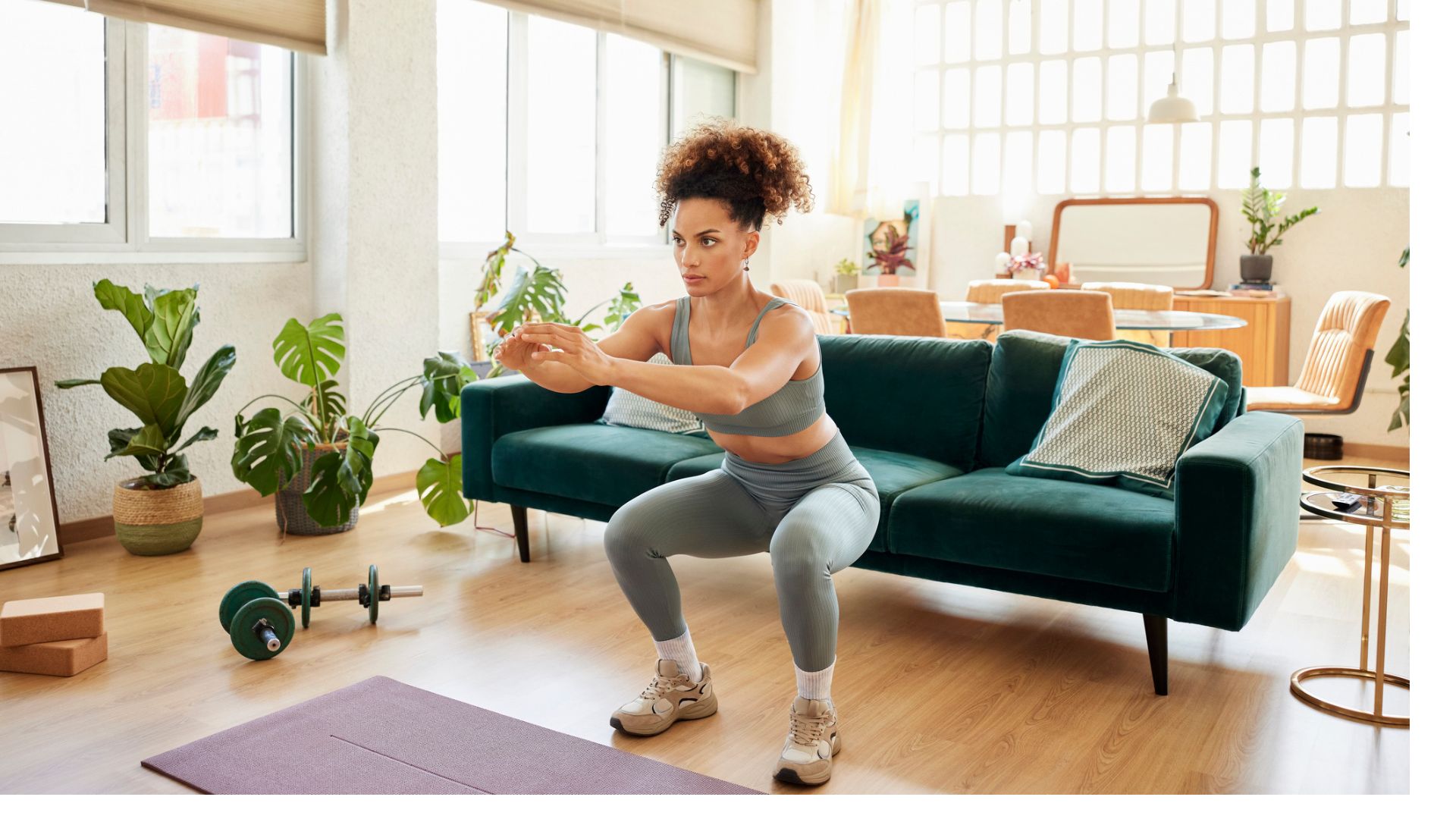 woman does bodyweight squat in her living room