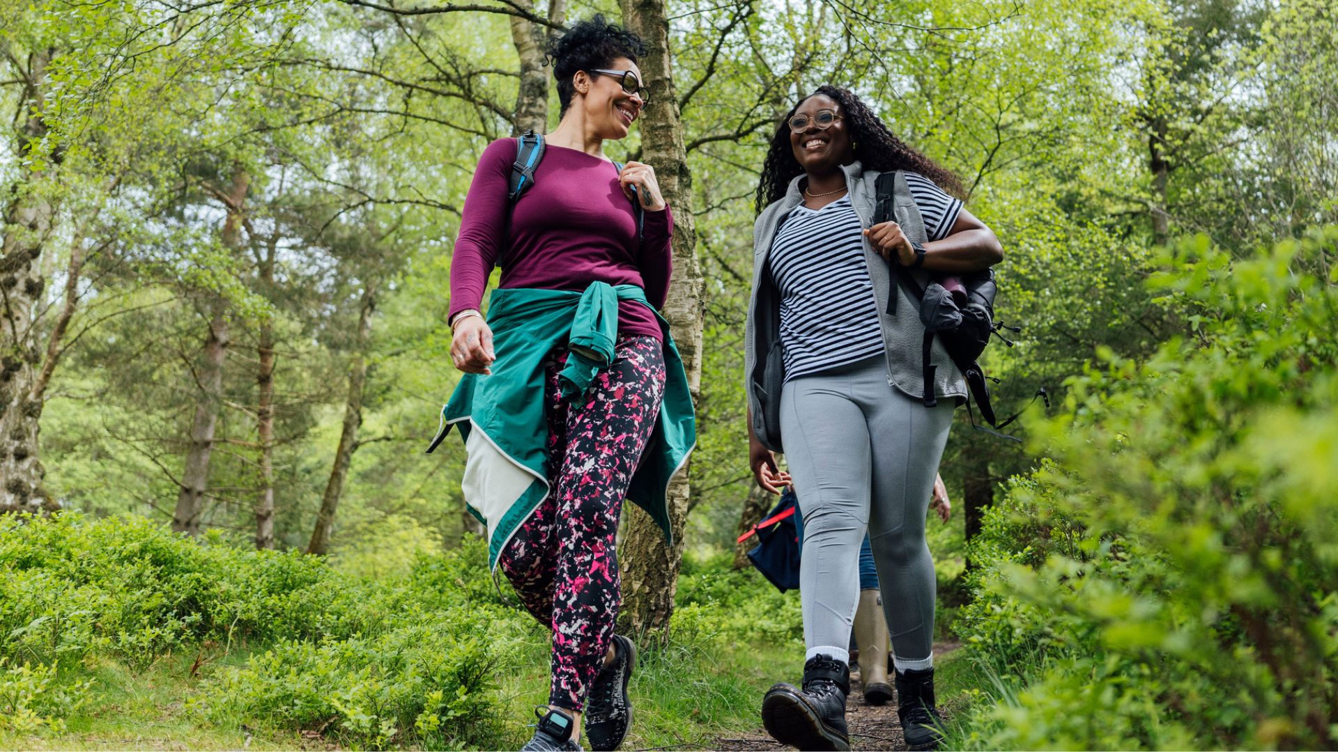 woman walking through a wooded area on a hike