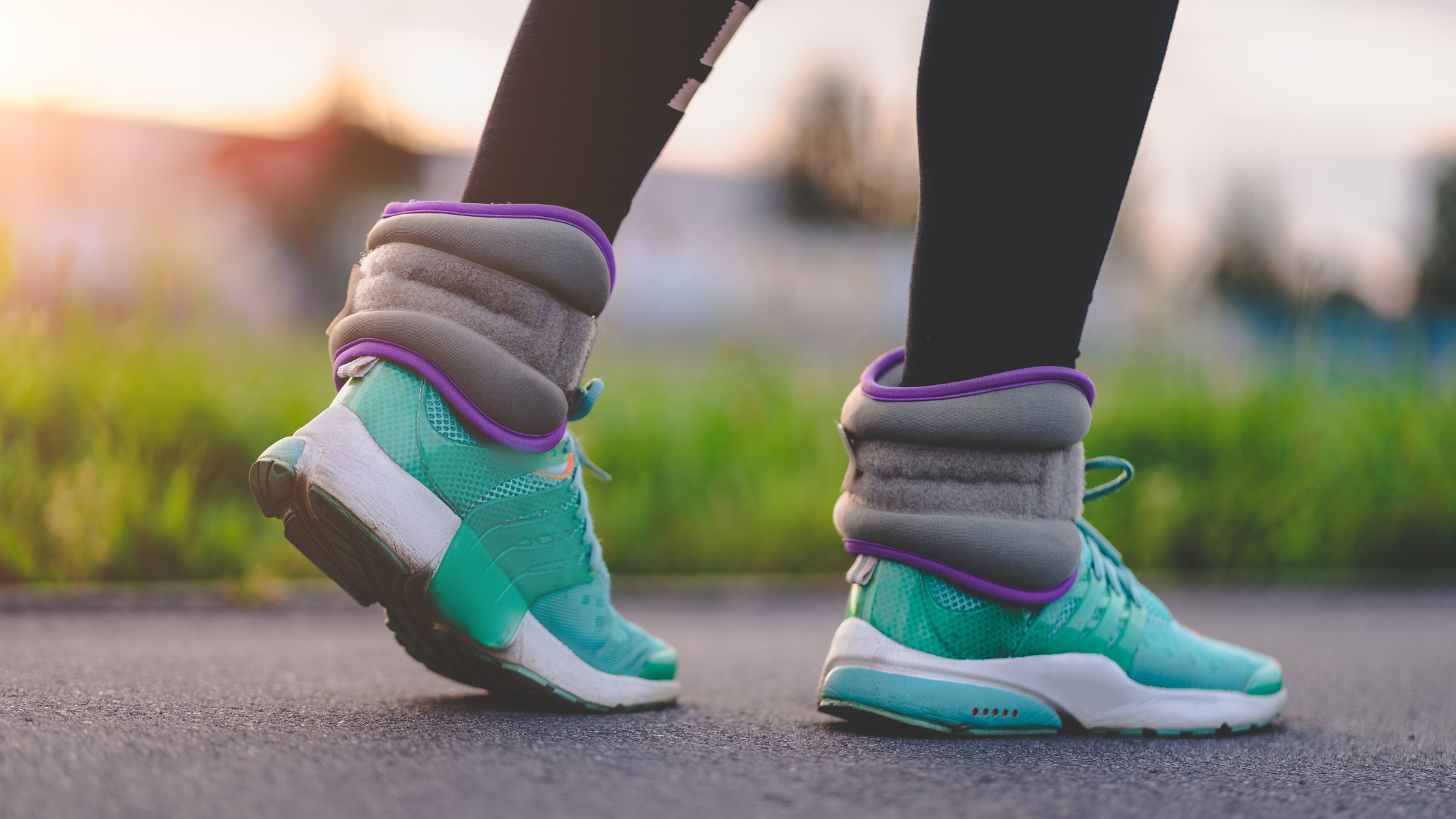 Feet and lower legs on Tarmac outside wearing ankle weights