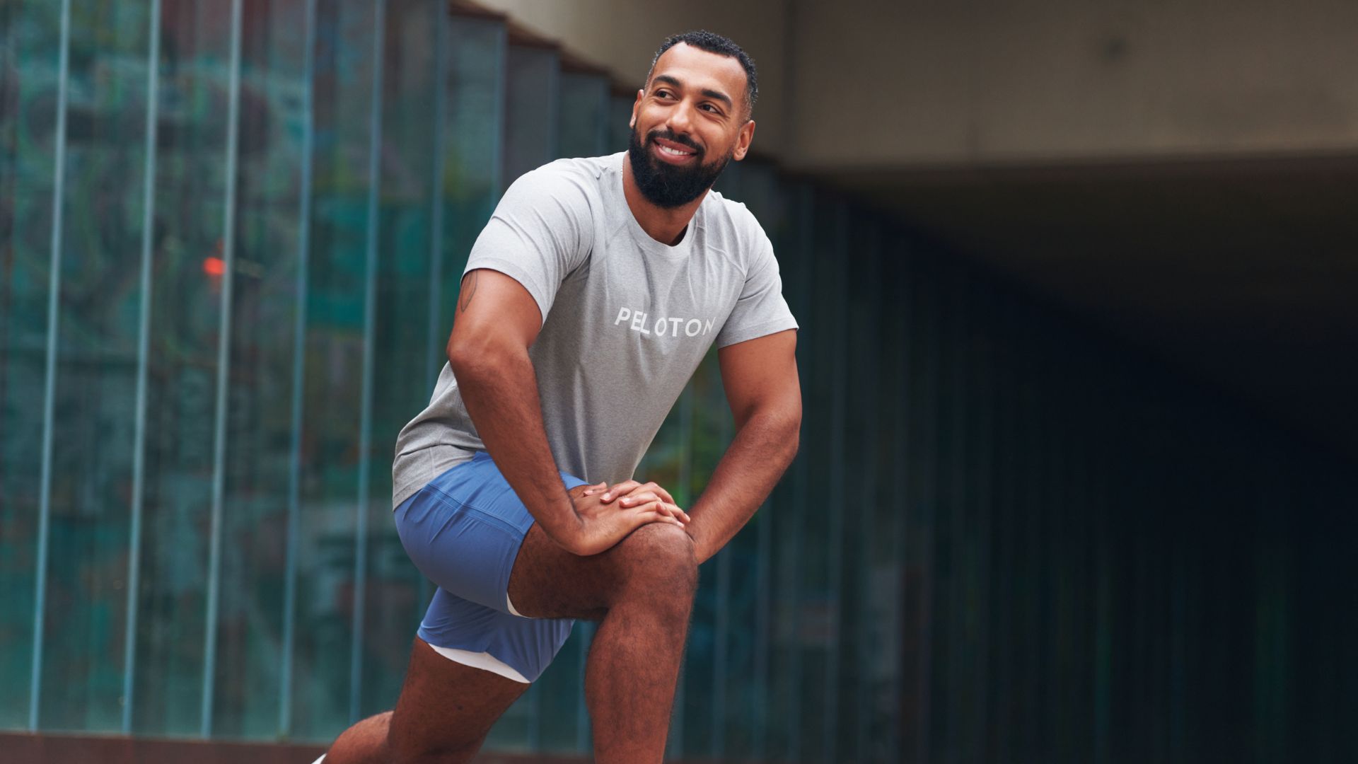 Man kneels down mid stretch after a run