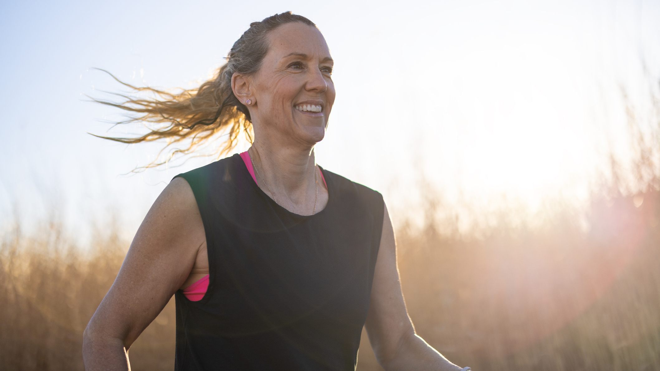 Smiling woman running outside